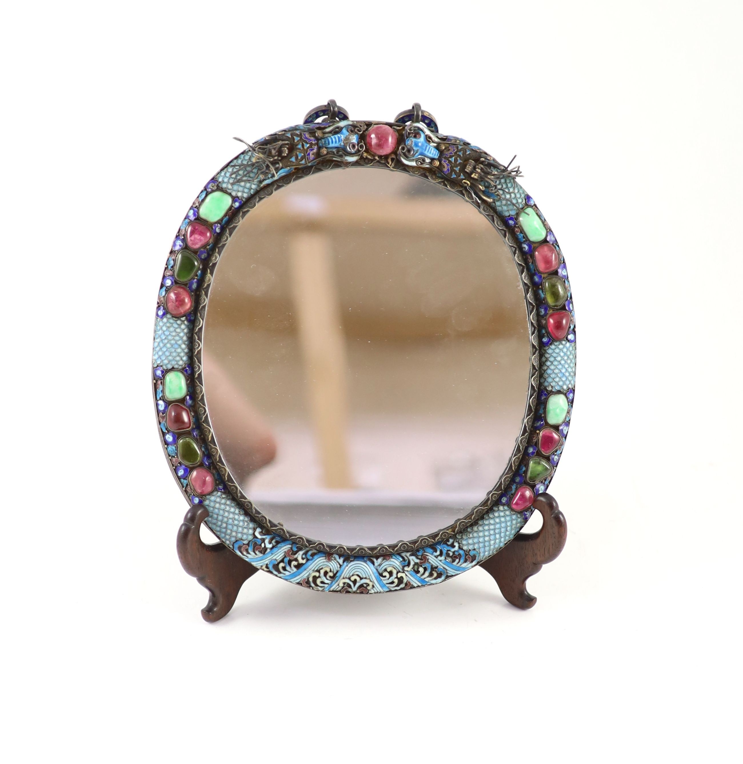 A Chinese white metal cloisonné enamel and gem set wall mirror, mid 20th century, 29.5cm to suspension loop 22.5cm wide, wood stand
